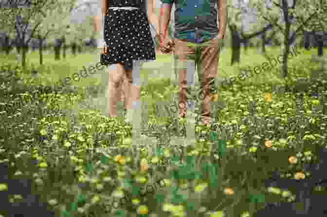 A Couple Holding Hands In A Field Of Wildflowers With A Charming Small Town In The Background Willowleaf Lane: A Clean Wholesome Romance (Hope S Crossing 5)