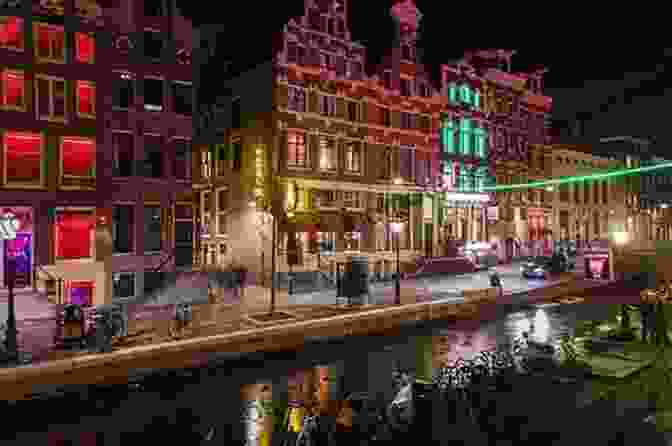 The Red Light District Is One Of The Most Famous Areas In Amsterdam. This Photo Shows The District At Night, With Its Many Neon Lights And Bars. Amsterdam Travel Guide With 100 Landscape Photos